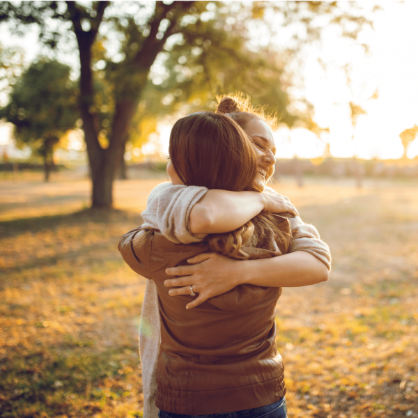 Photo of two people showing support